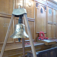 Ships' Bell of the SS Marquerite with the ' in Memoriam 'wall to the 6th Battalion, City of London Rifles in the background.